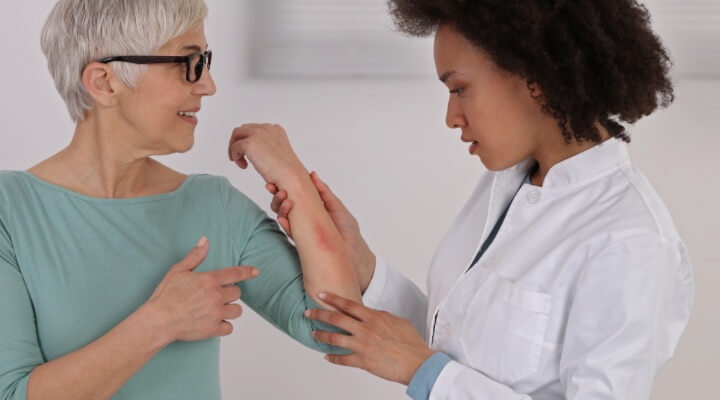 dermatologist inspecting rash